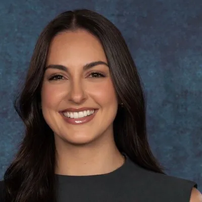 Woman with dark hair smiling at the camera