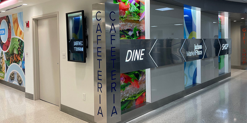 The entrance of a cafeteria, there's a sign that reads Central Market