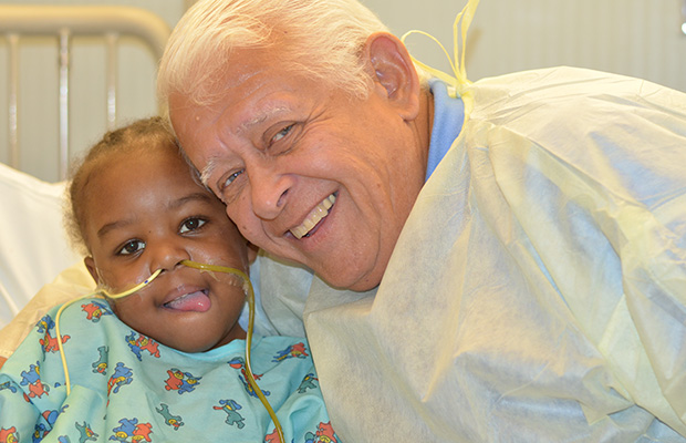 Juan Manfredi in the hospital smiling with his grandaughter