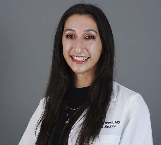 Close-up of a woman wearing a doctor's coat.