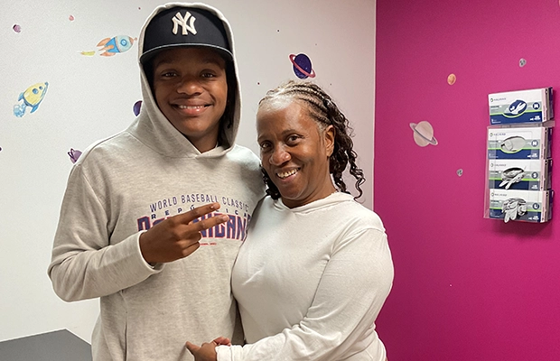 young boy posing next to a lady