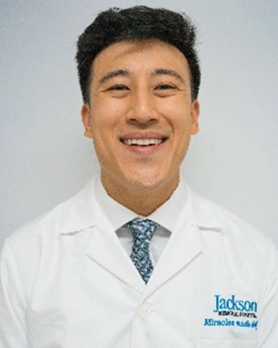 Professional headshot of Kevin-H, a man smiling, against a white studio background