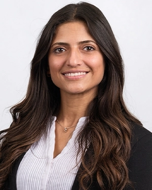 Close-up of a woman in a suit smiling at the camera.
