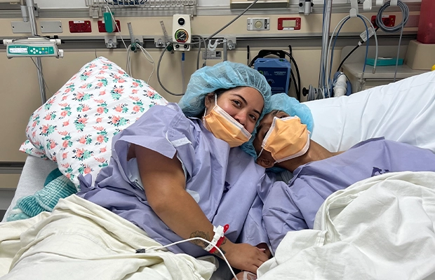 A couple lying on a hospital gurney before an operation