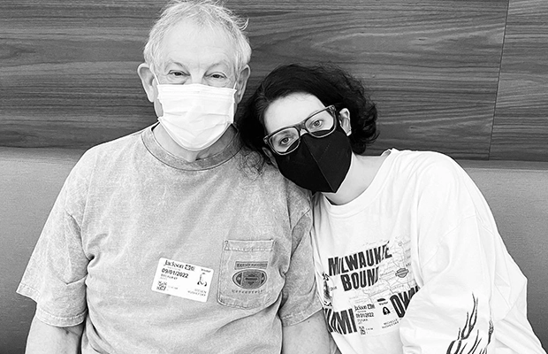 Black and white photograph of a man and a woman sitting and embracing each other