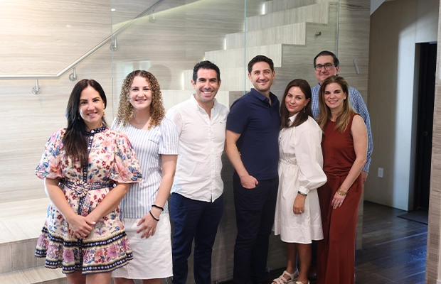 a group of people posing and smiling at the camera