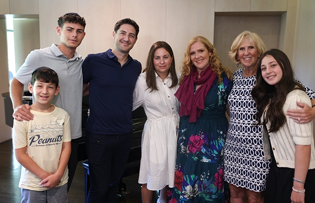 a group of people posing and smiling at the camera