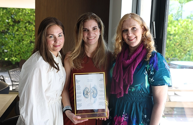 three people posing and smiling at the camera