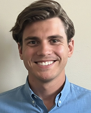 Close-up of a man wearing a blue shirt.