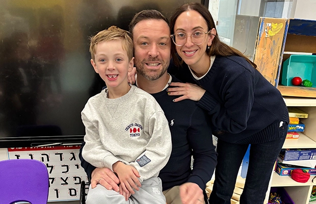 child sitting on his parents' lap