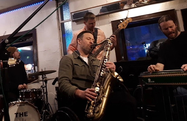 man playing saxophone during event