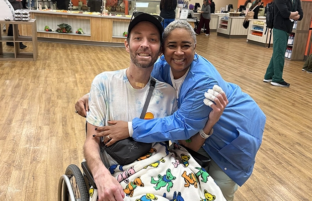 woman hugging man in wheelchair