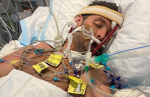 fully intubated man on hospital gurney