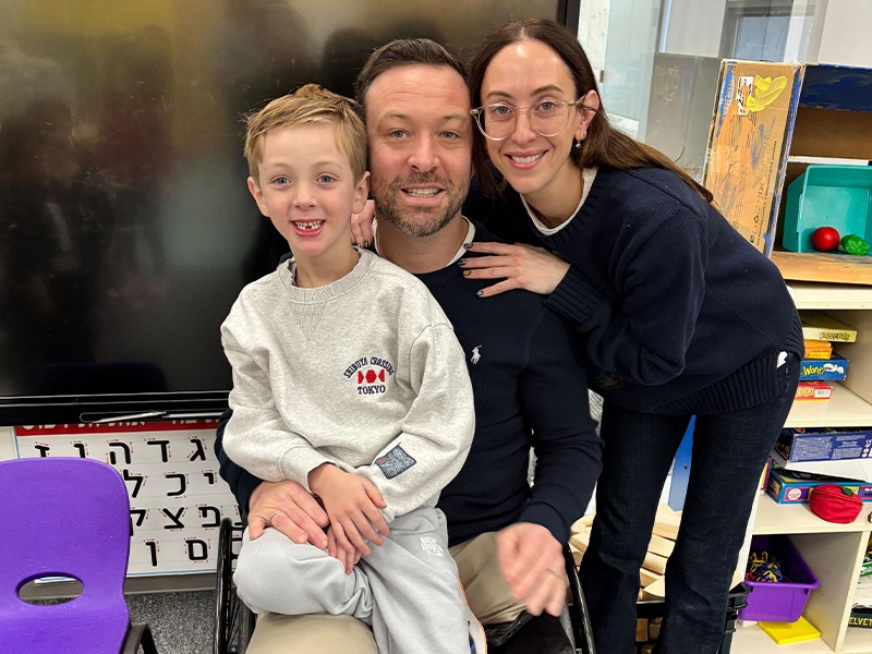 child sitting on his parents' lap