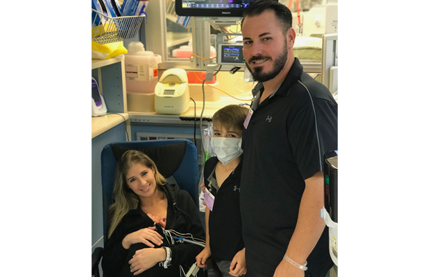 Lilia Silva in the hospital with her husband, son, and newborn daughter