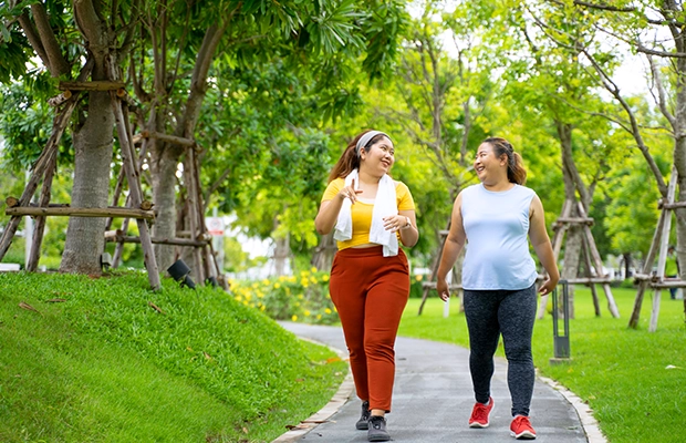 two women walking in the park