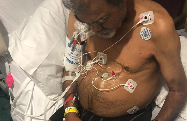 man covered in bandages and in a tube