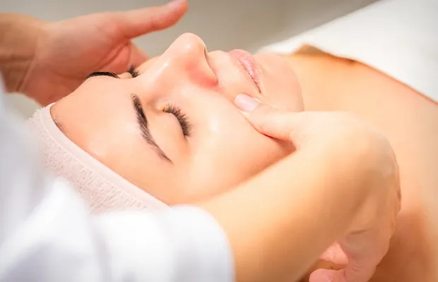 Close-up of a woman receiving a facial massage