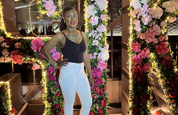 A woman standing in front of a sign that reads STK