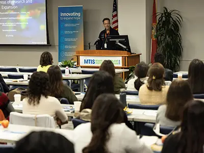 A presenter speaking to an audience