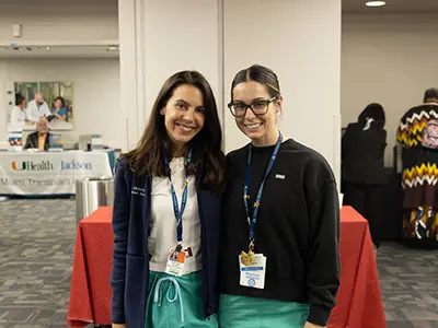 Two medical professionals smiling at the camera