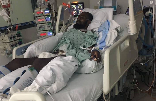 Man intubated and bandaged on hospital stretcher