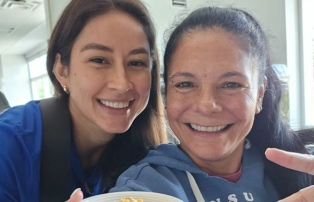 selfie where women embrace each other smiling at the camera