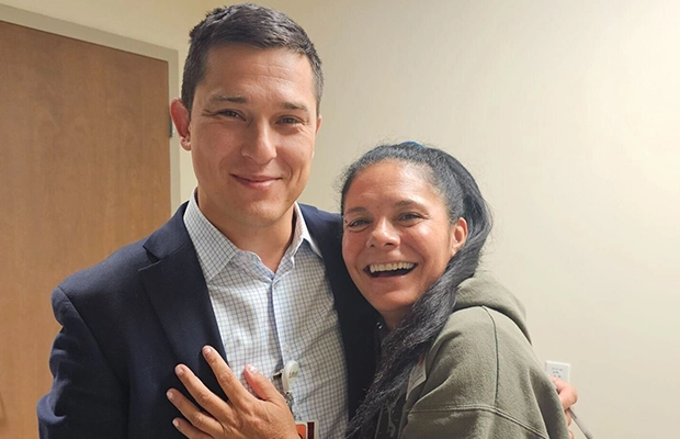 selfie where a couple embrace each other smiling at the camera