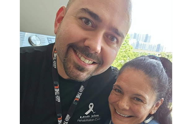 selfie where two people embrace each other smiling at the camera