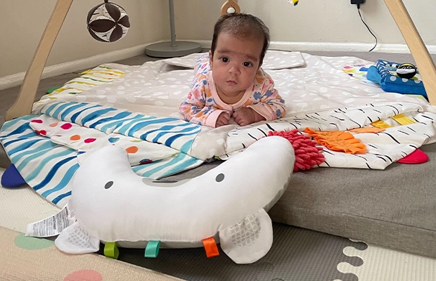 baby surrounded by toys