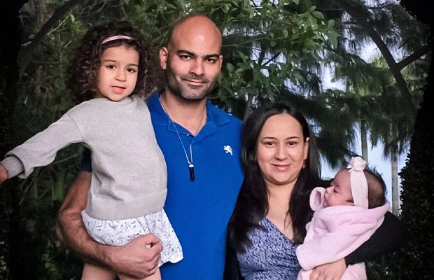couple holding up their two children