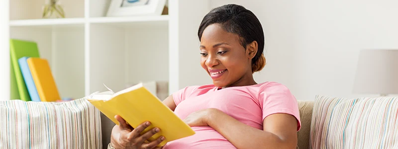 A pregnant woman reading a book
