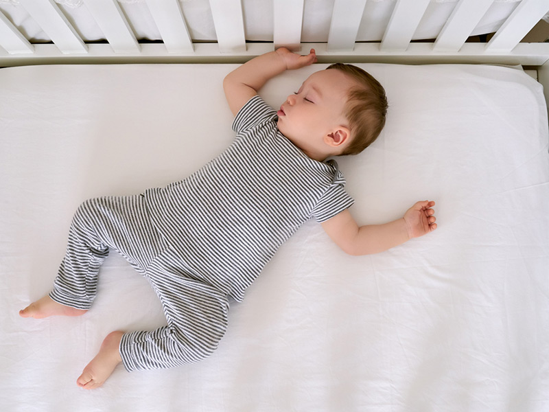 A baby sleeping in a crib