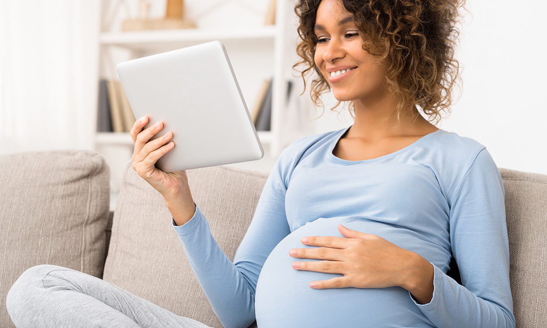 Sleeping pregnant woman is resting on the yellow chair Stock