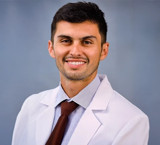Close-up of a man wearing a doctor's coat.