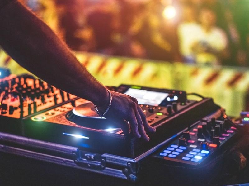 Close-up of a DJ's hands playing in a bar