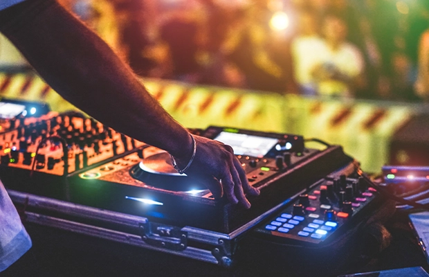 Close-up of a DJ's hands playing in a bar