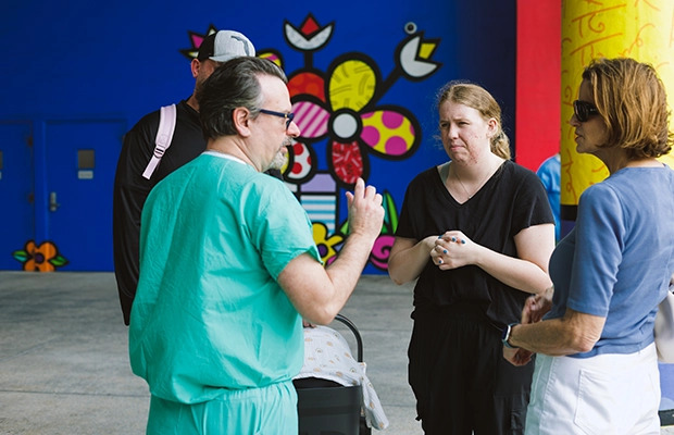 four people talking on the street