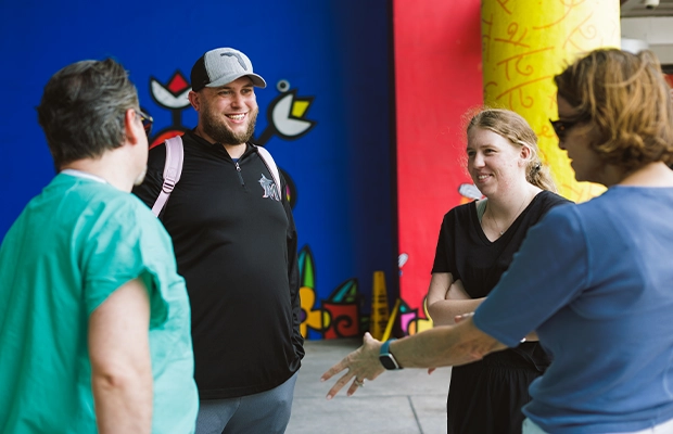 four people talking on the street