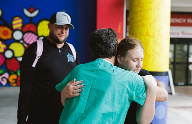 A woman hugging a doctor while smiling