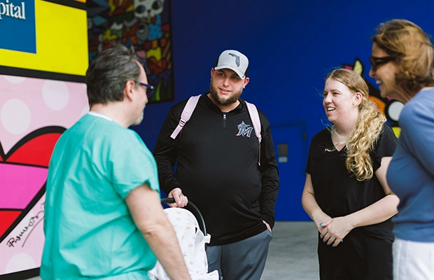 four people talking on the street