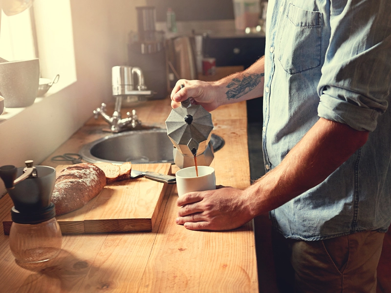 man preparing coffee in the kitchen
