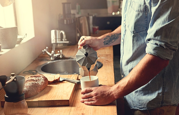 man preparing coffee in the kitchen