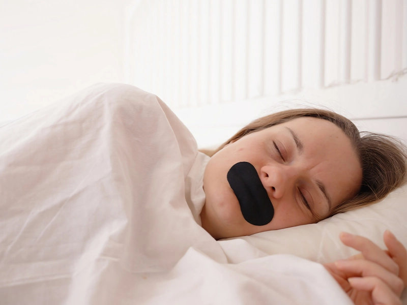 woman sleeping with a patch over her mouth