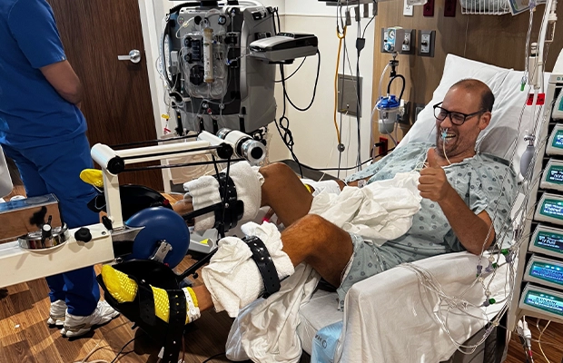 Man smiling from a hospital bed
