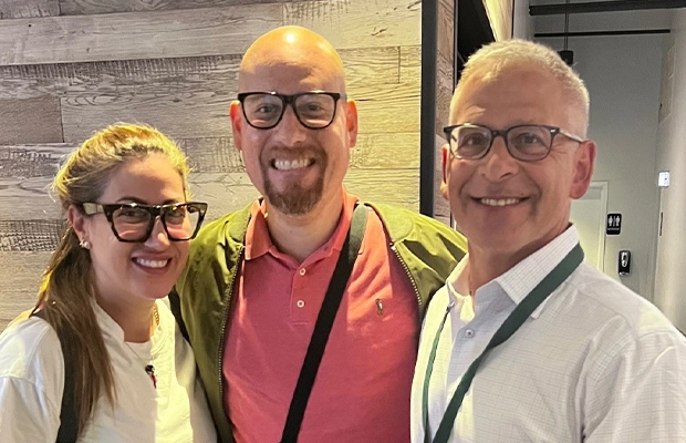 Three people posing and smiling at the camera