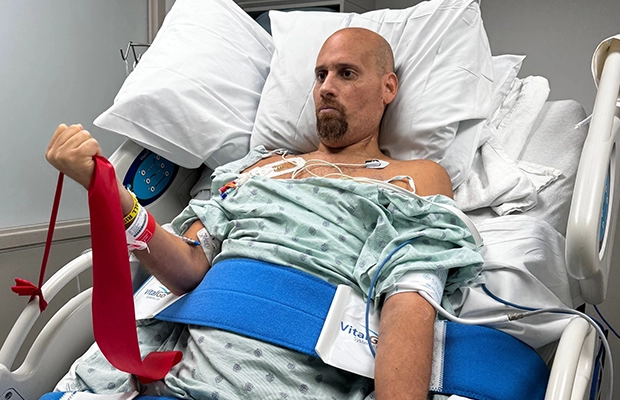 Man undergoing therapy from a hospital bed