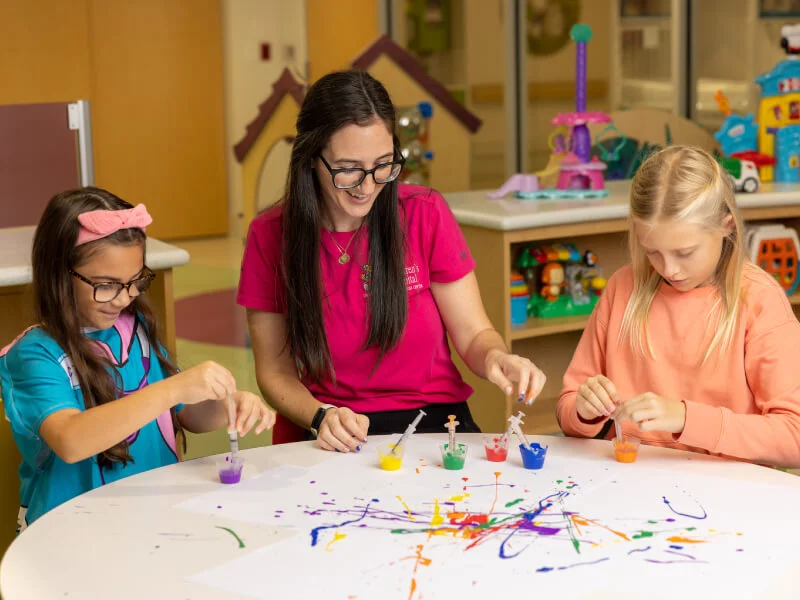 A woman and children doing arts and crafts together