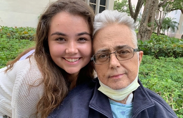 young woman smiling next to adult man