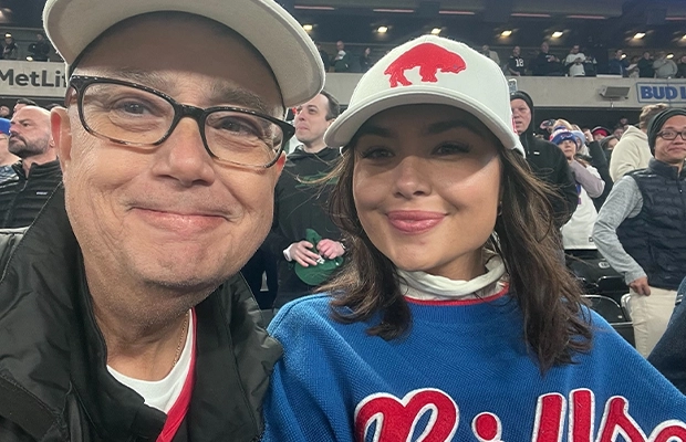 man and girl smiling at camera during football game